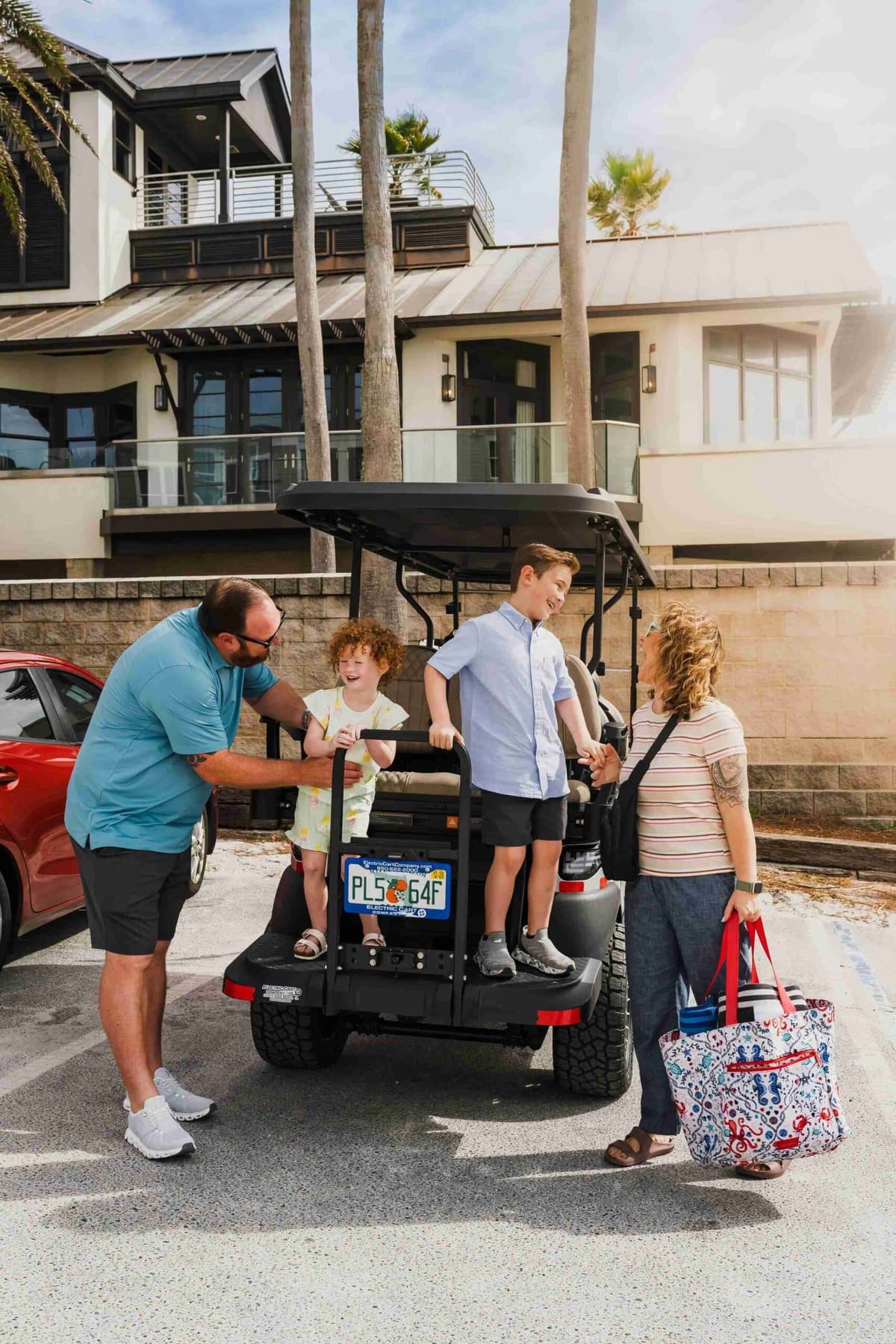 A family enjoying a beach day on 30A with their Electric Cart Company rental cart